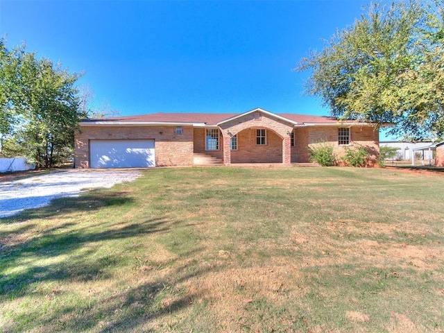 ranch-style house featuring a garage and a front yard