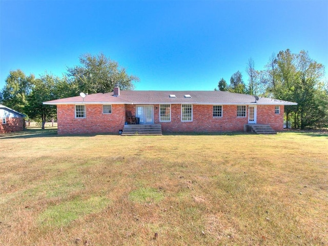 back of property with a lawn