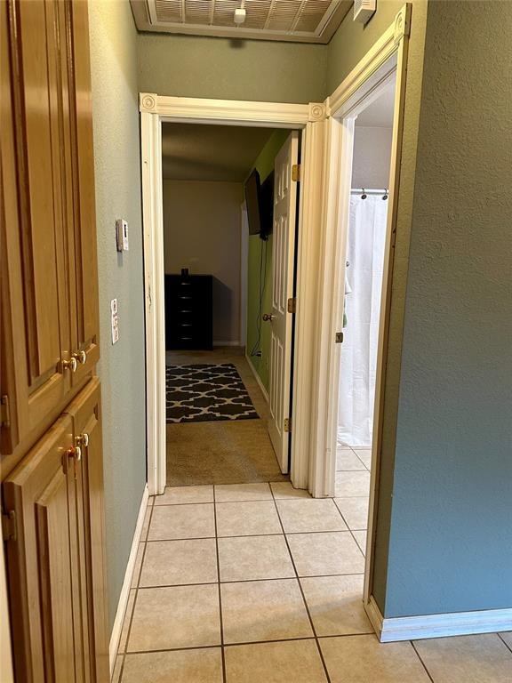 corridor featuring light tile patterned floors