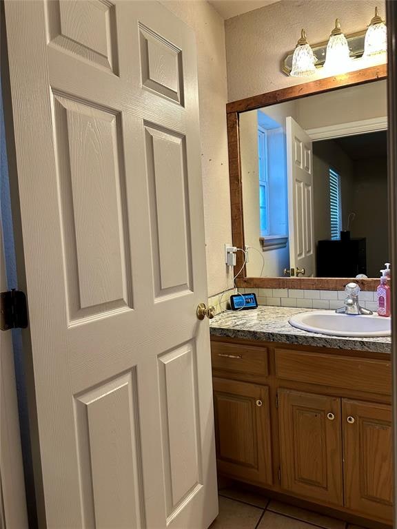 bathroom with tile patterned flooring and vanity