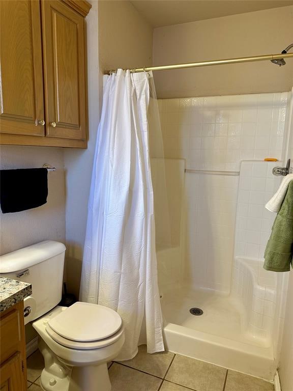 bathroom with curtained shower, tile patterned flooring, vanity, and toilet