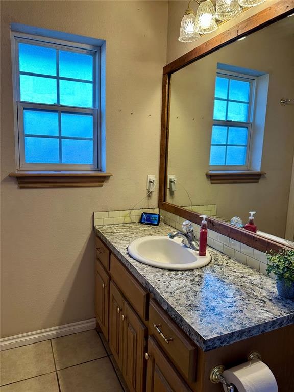 bathroom featuring tile patterned flooring, vanity, and plenty of natural light