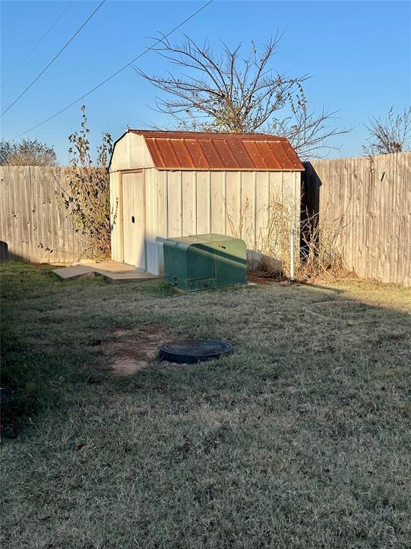 view of outbuilding featuring a lawn