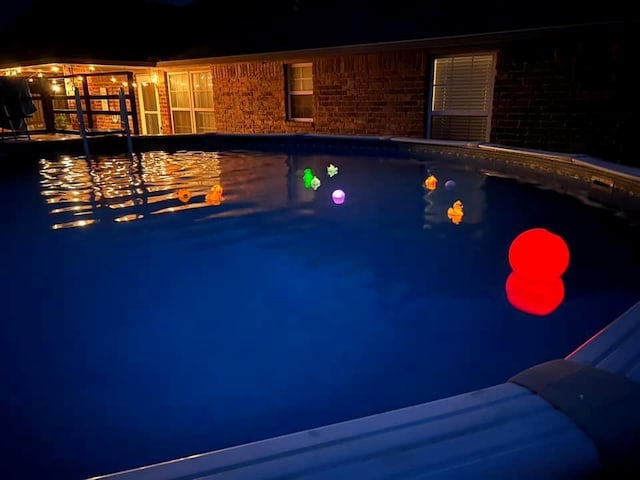 view of pool at night