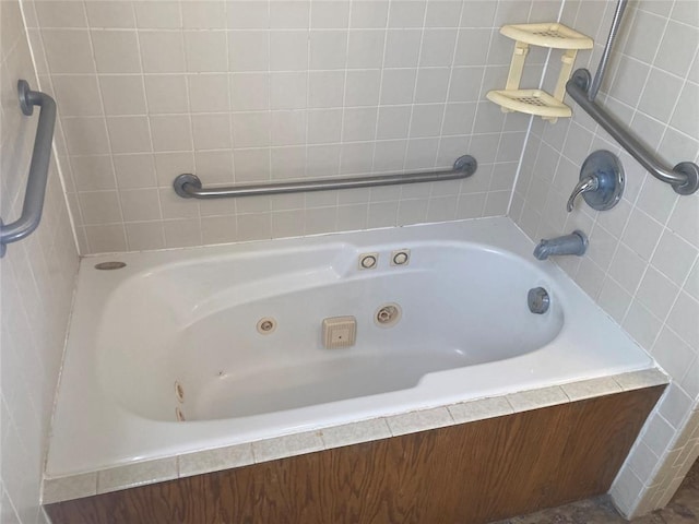 bathroom with a relaxing tiled tub