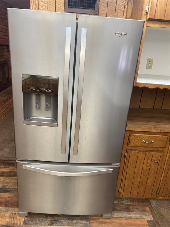 kitchen featuring dark hardwood / wood-style flooring and stainless steel refrigerator with ice dispenser