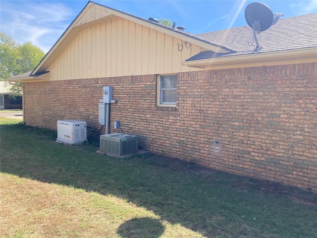 view of property exterior with a lawn and central air condition unit