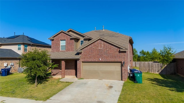 view of front of house featuring cooling unit, a garage, and a front lawn