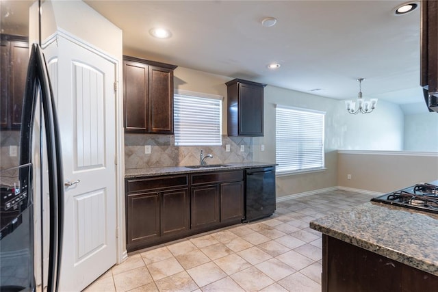 kitchen featuring sink, a notable chandelier, backsplash, decorative light fixtures, and black appliances