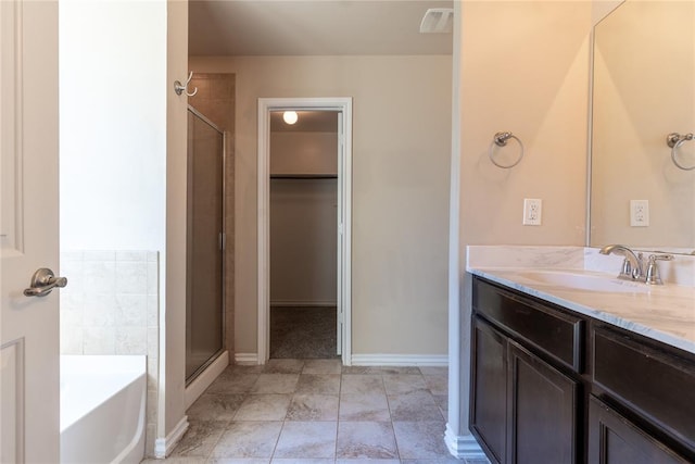 bathroom with tile patterned floors, vanity, and separate shower and tub