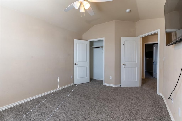 unfurnished bedroom with ceiling fan, a closet, carpet floors, and vaulted ceiling