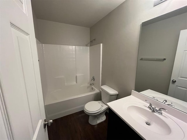 full bathroom featuring vanity, hardwood / wood-style flooring, toilet, and shower / washtub combination