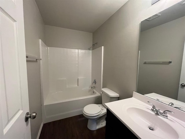 full bathroom featuring hardwood / wood-style floors, vanity, toilet, and bathing tub / shower combination