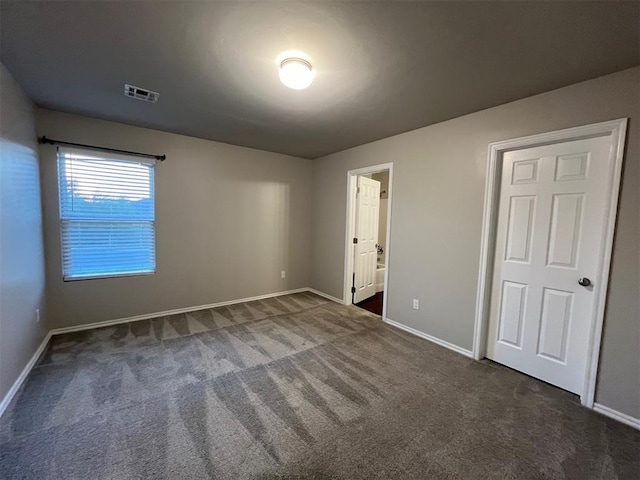 unfurnished bedroom featuring dark colored carpet