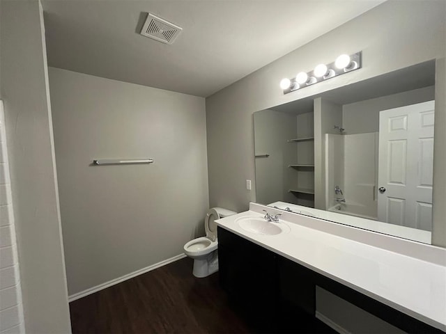 full bathroom featuring shower / washtub combination, toilet, vanity, and hardwood / wood-style flooring