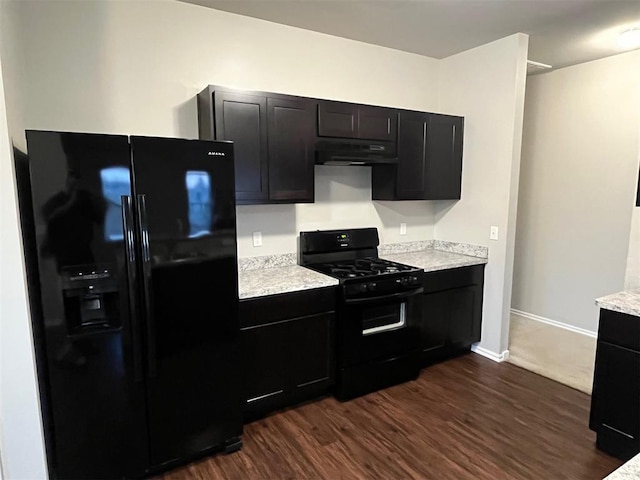 kitchen featuring dark wood-type flooring and black appliances