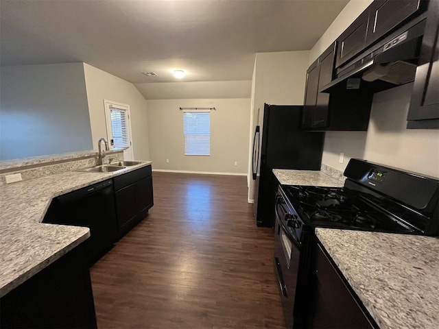 kitchen with light stone counters, sink, black appliances, dark hardwood / wood-style floors, and lofted ceiling