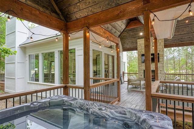 wooden deck with a hot tub