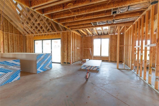 misc room featuring concrete flooring and a wealth of natural light