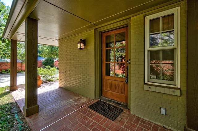 view of exterior entry featuring a porch