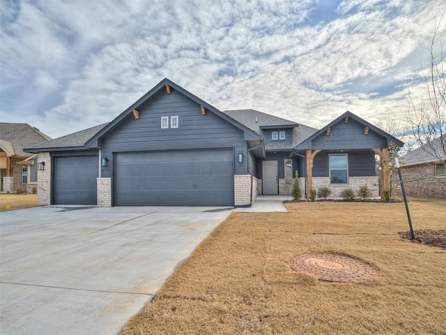 view of front of home with a garage and a front yard