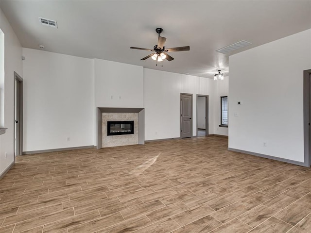 unfurnished living room with light hardwood / wood-style flooring and ceiling fan