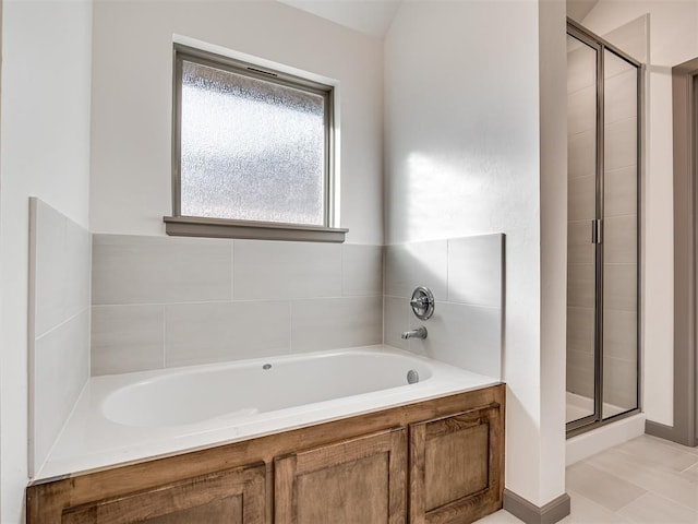 bathroom featuring independent shower and bath