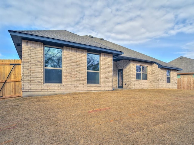 back of property featuring a lawn