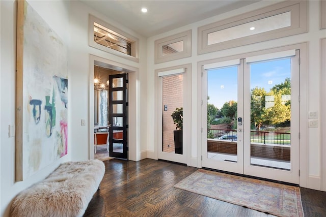 doorway to outside featuring a chandelier, french doors, and dark hardwood / wood-style floors