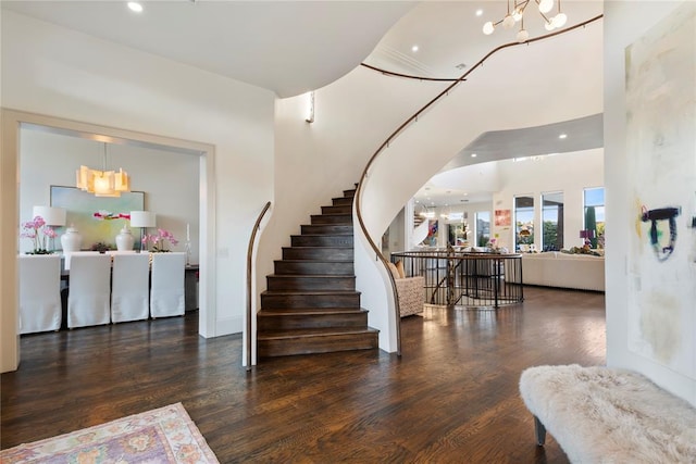 entryway with a notable chandelier and dark wood-type flooring