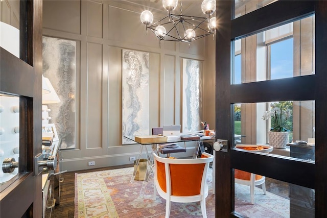 dining area with dark hardwood / wood-style floors and a notable chandelier