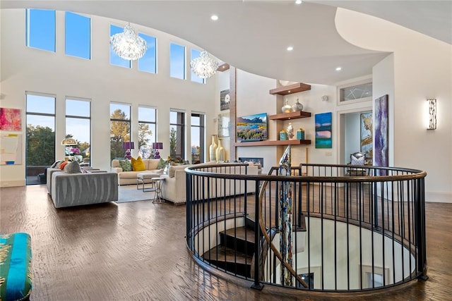 interior space featuring a chandelier, a high ceiling, and hardwood / wood-style flooring