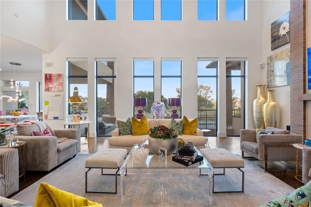 living room featuring hardwood / wood-style floors and a towering ceiling