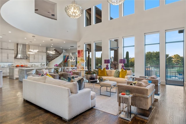 living room featuring a chandelier, a high ceiling, and dark hardwood / wood-style flooring