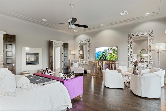 bedroom featuring ceiling fan, dark hardwood / wood-style flooring, and crown molding