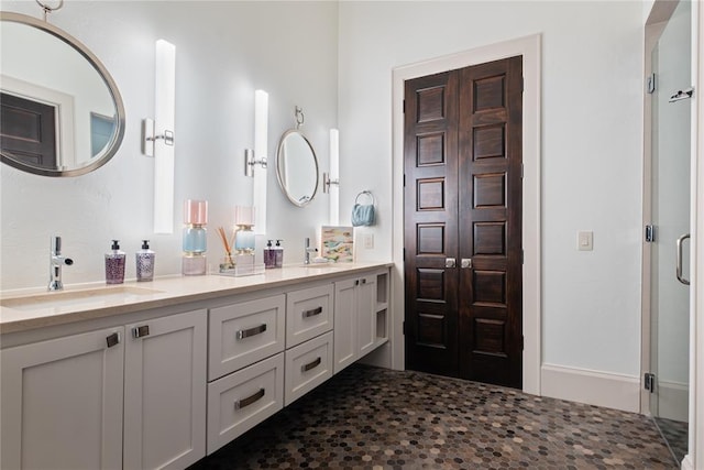 bathroom featuring vanity and an enclosed shower