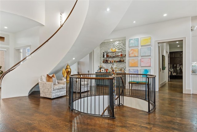 interior space with a high ceiling and hardwood / wood-style flooring