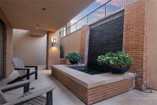 view of patio terrace at dusk