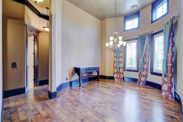 interior space with hardwood / wood-style floors and an inviting chandelier