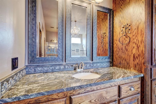 bathroom featuring vanity and a notable chandelier