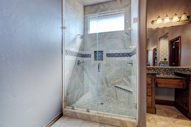 bathroom featuring a shower with door, vanity, and tile patterned flooring