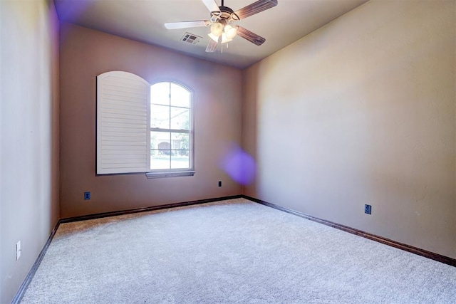 carpeted spare room with ceiling fan