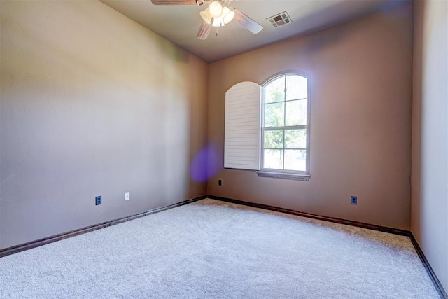 empty room featuring carpet floors and ceiling fan