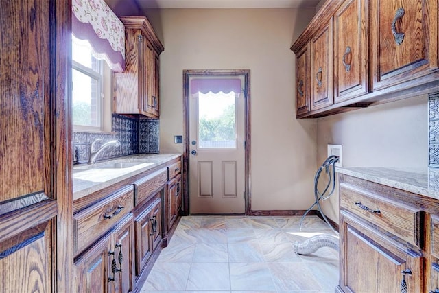 laundry room featuring cabinets, washer hookup, a healthy amount of sunlight, and sink