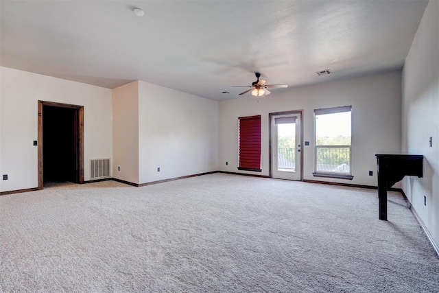 empty room with light colored carpet and ceiling fan