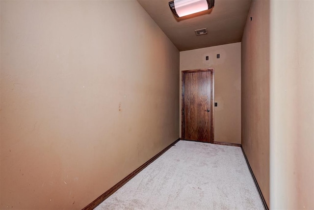 hall featuring light colored carpet and vaulted ceiling