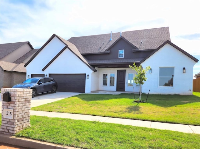 view of front facade with a garage and a front lawn