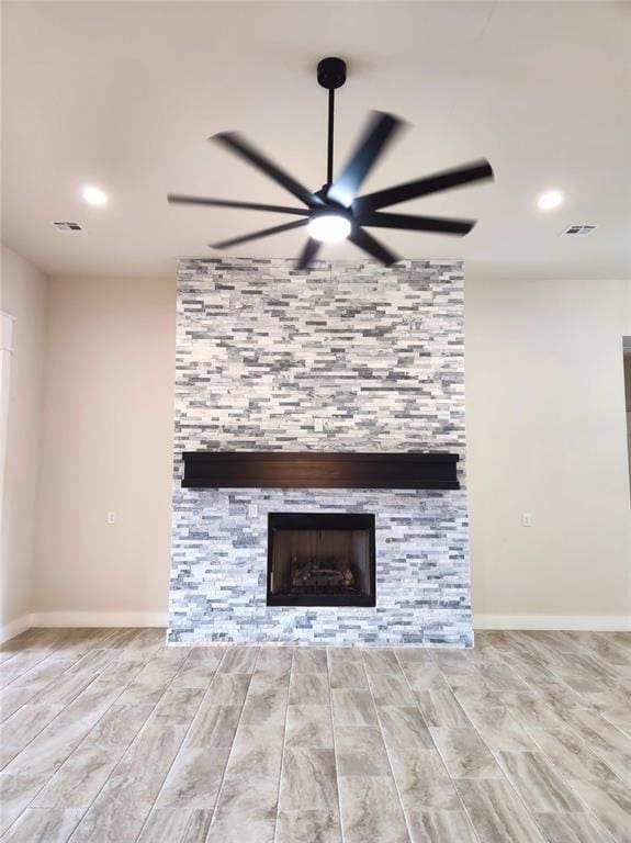 interior details with a fireplace, hardwood / wood-style flooring, and ceiling fan