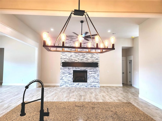 living room featuring hardwood / wood-style floors and a stone fireplace