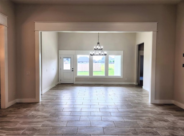 unfurnished dining area featuring a notable chandelier